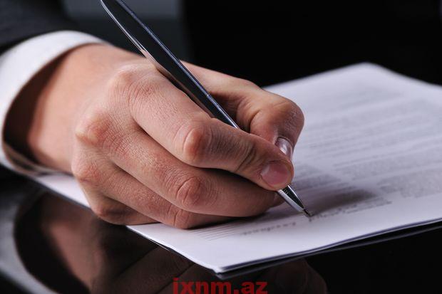 businessman writing on a form